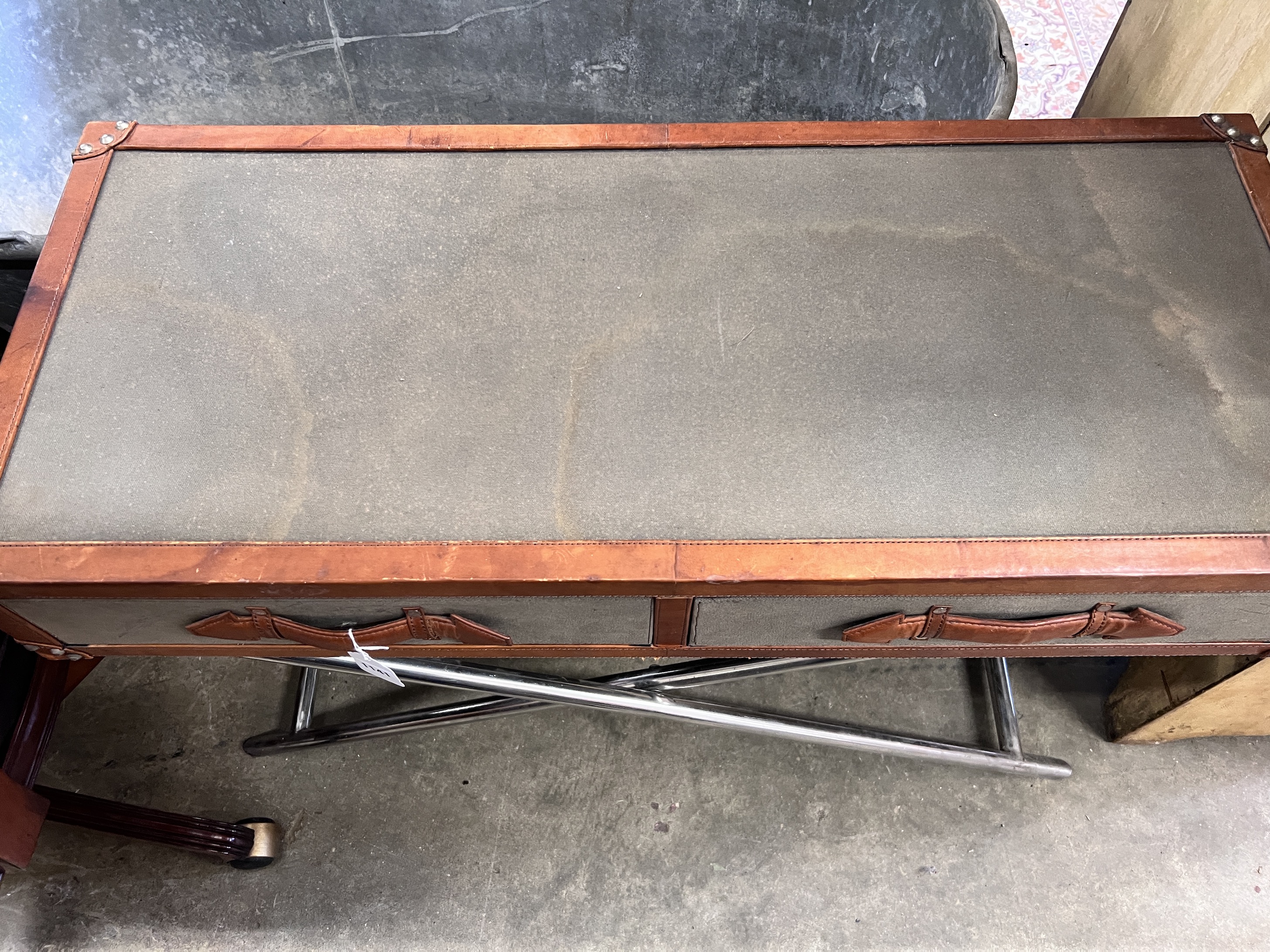 A leather and canvas covered safari style occasional table with chromed folding underframe, width 96cm